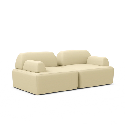 The Magna Preconfigured Sectional is a contemporary, beige sofa featuring plush cushions and a minimalist design, complete with armrests and two connected seating sections, all showcased against a white background.