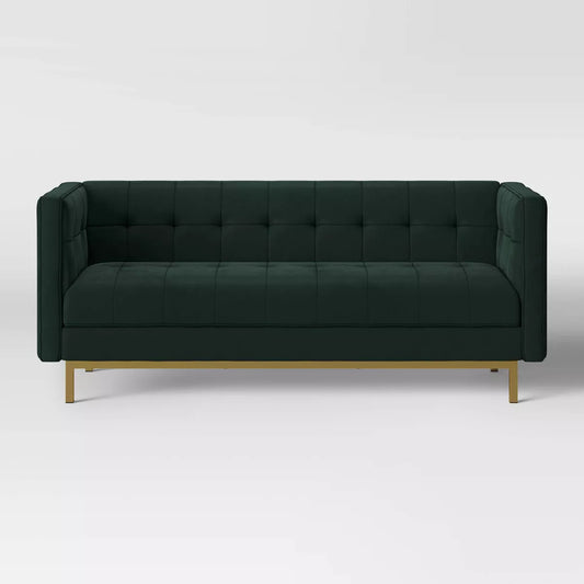 The Cologne Modern Luxe Tufted Sofa in Emerald Green by Threshold™ features a dark green velvet finish with a tufted backrest and arms, elegantly supported by sleek gold metal legs. Its modern, boxy design is displayed against a plain white background.