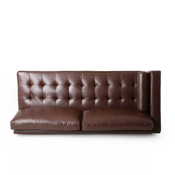 The Malinta Contemporary Tufted Upholstered Chaise Sectional from Christopher Knight Home is a brown leather sofa with a high backrest and tufted design, featuring two large seat cushions. Its minimalist style and deep color lend it a modern and elegant appearance against the white background.