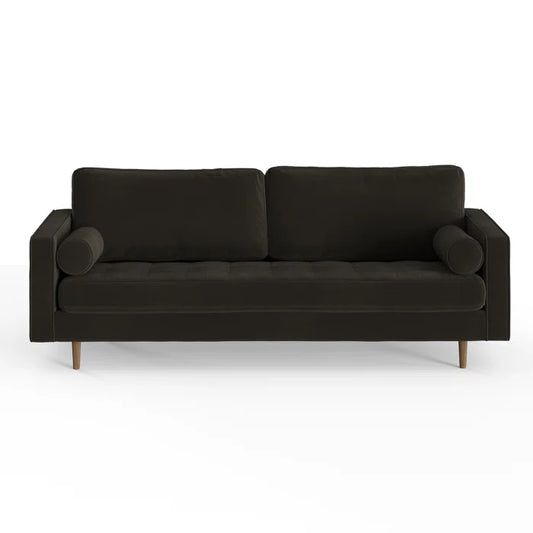 The Geo 84'' Upholstered Sofa is a modern, dark green piece with a sleek design. It includes two back cushions, a tufted seat, and cylindrical armrest pillows. The sofa stands on wooden legs and is displayed against a plain white background.