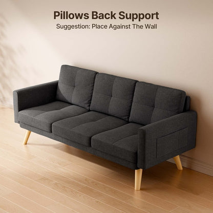 A contemporary dark gray Sofa Couch Small Loveseat with wooden legs is set on a light wooden floor. Text above recommends enhancing comfort by placing the loveseat against the wall to utilize its back support pillows. The room features a minimalist design.