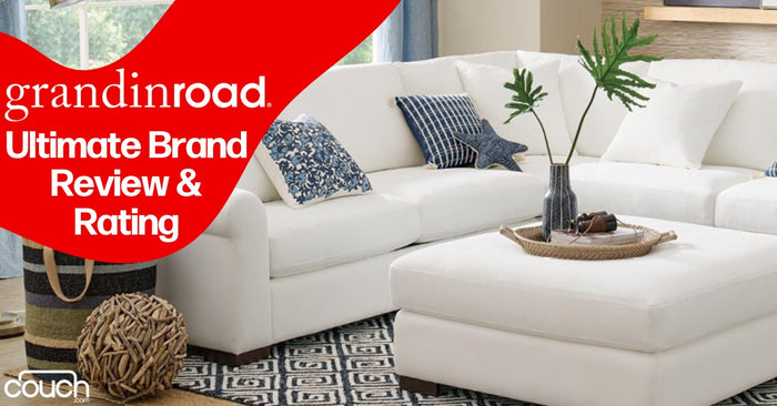 Living room with a white sectional sofa and a large ottoman. There are blue and patterned cushions, a decorative wooden tray with plants, and a patterned rug. Text overlay reads: "grandinroad: Ultimate Brand Review & Rating.