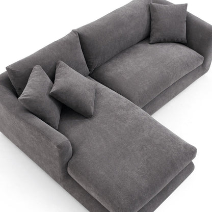 The Feathers 88" Left Facing Sectional is a contemporary grey sofa with soft cushions, featuring a left-sided chaise lounge, set against a white background.