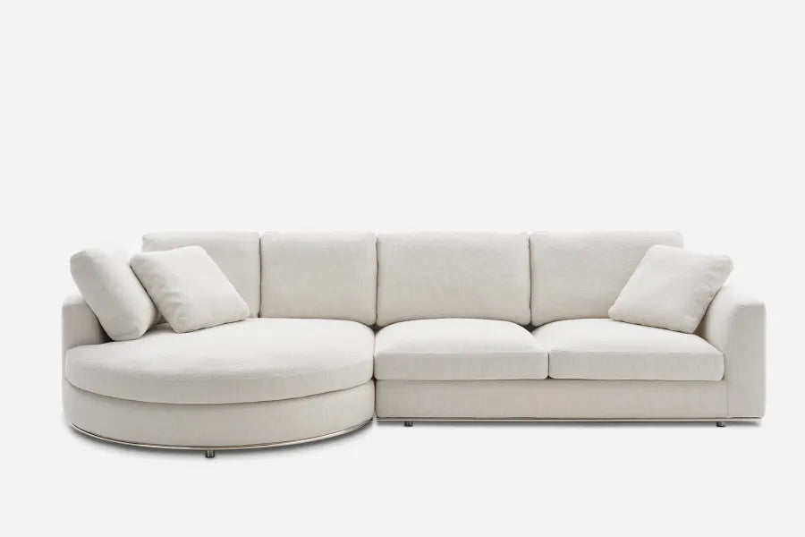 Beige sectional sofa with plush cushions, featuring a unique round chaise on the left and rectangular seats on the right, against a plain white background.