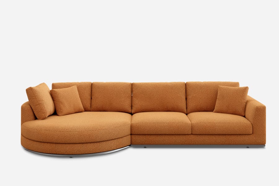 A large, modern sectional sofa upholstered in a textured, burnt orange fabric. The left side features a rounded chaise, and several matching cushions are placed on the backrests. The sofa is set against a plain white background.