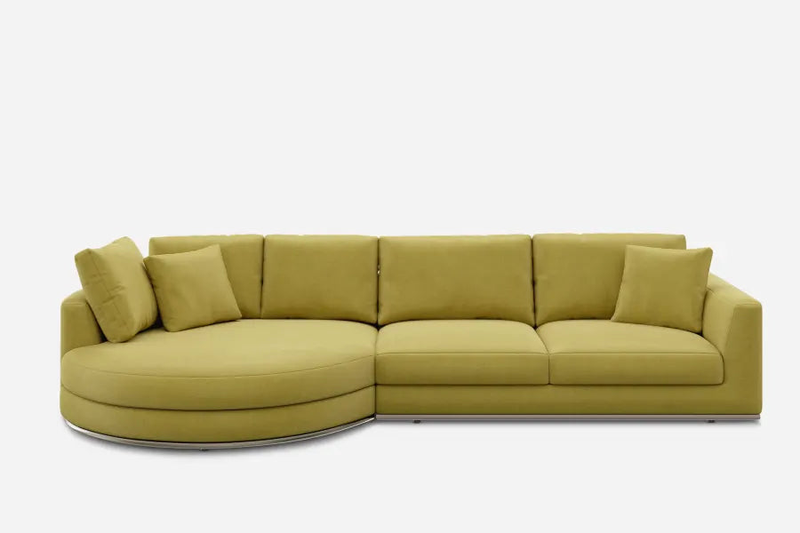 A modern, olive-green sectional sofa with a left-facing curved chaise and four back cushions. The design is sleek, with plush seating, set against a plain white background.