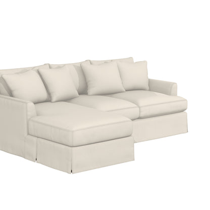 The Ava Chaise Slipcovered Sofa is a cream-colored sectional adorned with four large, square cushions. It boasts a sleek design set against a light, neutral background, highlighting its plush and comfortable appearance.