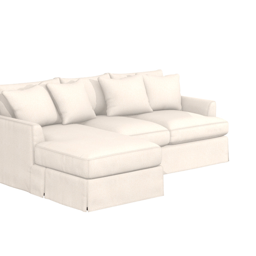 Introducing the Ava Chaise Slipcovered Sofa: an elegant off-white sectional sofa that comes with four matching throw pillows. It features a chaise on the left side and boasts a soft, inviting design, making it perfect for any living room setting.