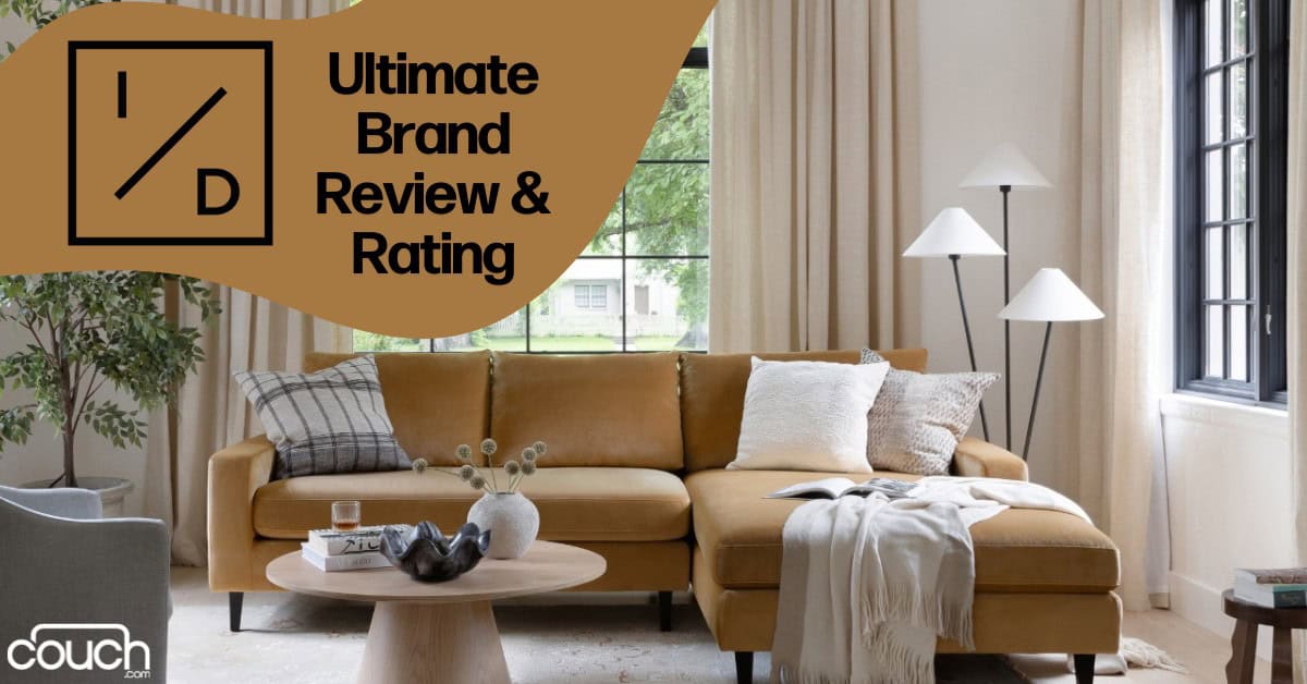 A stylish living room featuring a mustard-colored sectional sofa with various throw pillows and a blanket. A round wooden coffee table holds decorative items. Tall windows with light curtains and two modern floor lamps are in the background. Text reads "Ultimate Brand Review & Rating" and a logo.