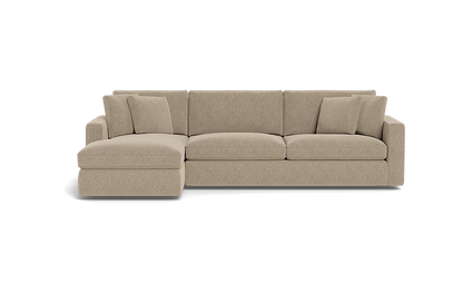 Introducing the James 3 Seat Left Chaise 92" Sectional, a beige sectional sofa featuring three large seat cushions and a left chaise lounge. The backrest is adorned with five plush cushions, complemented by wide armrests on each end. The sofa is elegantly displayed against a plain black background.