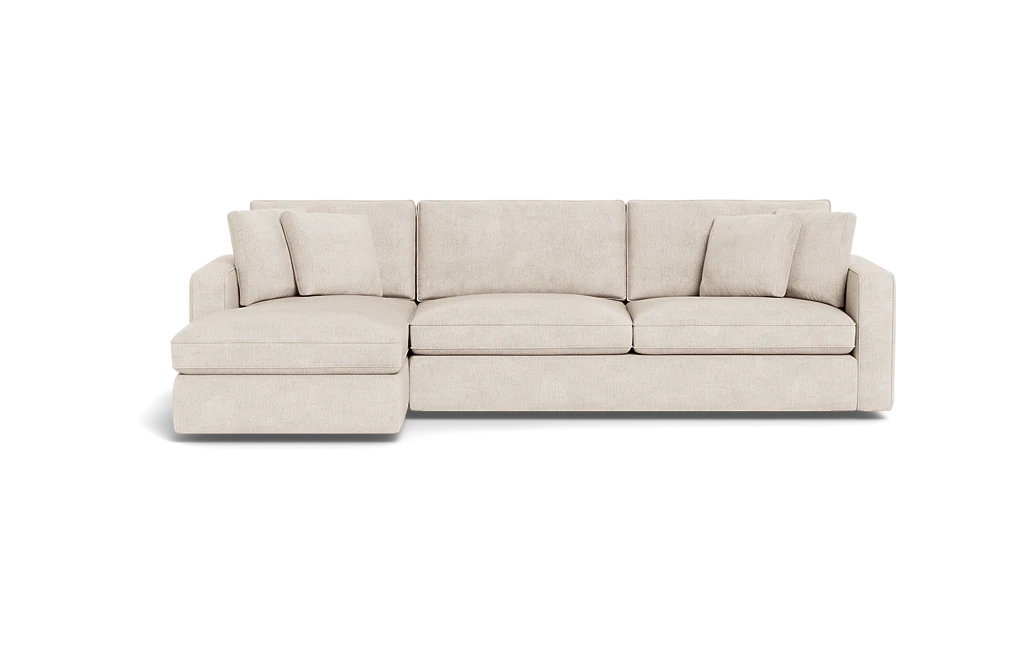 The James 3 Seat Left Chaise 92" Sectional is a beige sofa with an extended left-side chaise, three seat cushions, multiple back cushions, and is showcased against a black background. Its modern and minimalist design highlights clean lines.