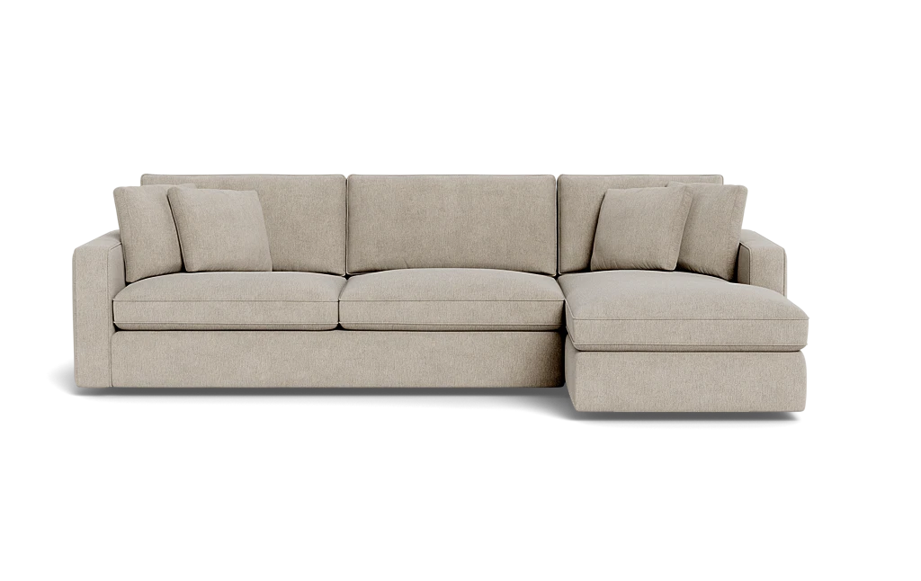 The James 3 Seat Left Chaise 92" Sectional is a beige sectional sofa featuring three seat cushions and an attached chaise on the left. It comes with three matching throw pillows, providing a clean and modern design.