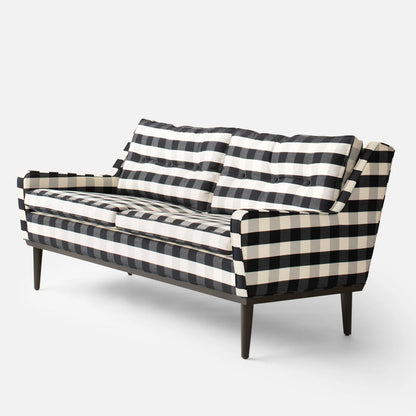 The Jack Sofa is a retro design with checkered black and white fabric, featuring a tufted backrest and cushions. It has slim, tapered wooden legs, giving it a stylish and modern appearance.