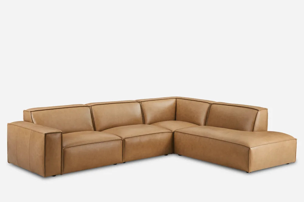 The Jonathan Leather Extended Side Chaise Sectional, a brown L-shaped leather sofa with clean lines and cushioned backrests, is set against a white background.