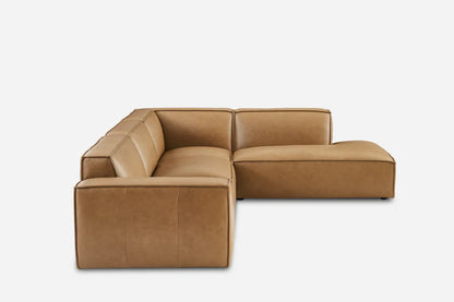 The Jonathan Leather Extended Side Chaise Sectional is a brown leather sofa featuring a modern design with clean, boxy lines and includes a chaise lounge extension on the right side, set against a plain white background.