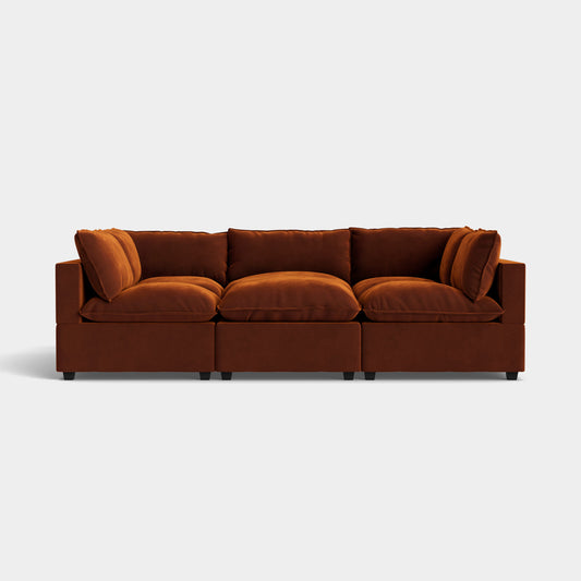 The Kova Pit, a brown three-seater modular sofa featuring plush cushions and a modern design, stands against a plain white background.