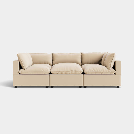 The Kova Pit, a beige modular sofa consisting of three sections complete with cushions and armrests, is arranged against a plain white background. Its sleek design and neutral color deliver a modern and versatile aesthetic.