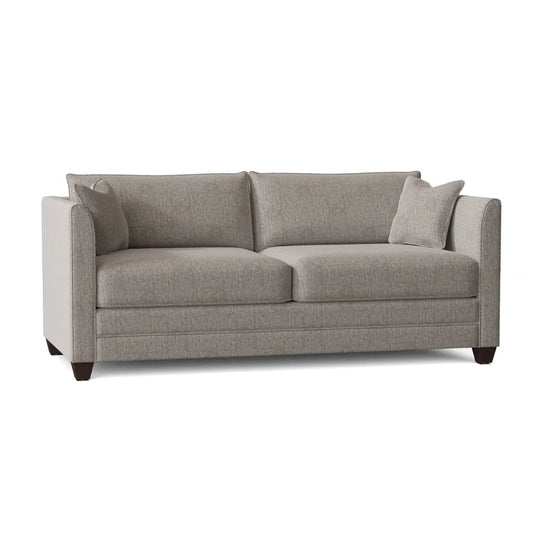 The Kodie 76.5" Upholstered Sleeper Sofa is a modern gray fabric piece featuring clean lines, two seat cushions, two back cushions, and two matching throw pillows, all set on dark wooden legs.