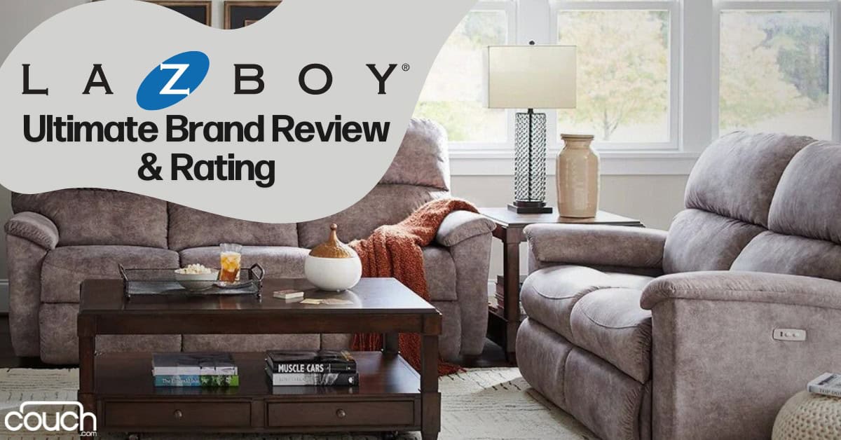 A cozy living room features two plush beige La-Z-Boy recliners, a matching loveseat, a wooden coffee table, and a side table with a lamp. The text "La-Z-Boy Ultimate Brand Review & Rating" is overlaid at the top left, with the "couch" logo at the bottom left.