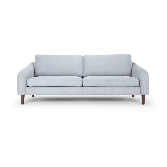 Introducing the Lana 85'' Upholstered Sofa: This minimalist piece comes in a light gray finish and captures mid-century modern style with its wooden legs. The sofa is designed with two seat cushions and two backrest cushions for ultimate comfort.