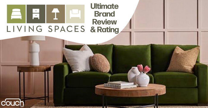 A cozy living room featuring a green sofa with matching cushions. A wooden side table with a lamp is placed beside it, and a coffee table with flowers and books in front. Text reads "Living Spaces Ultimate Brand Review & Rating." The couch.com logo is in the corner.