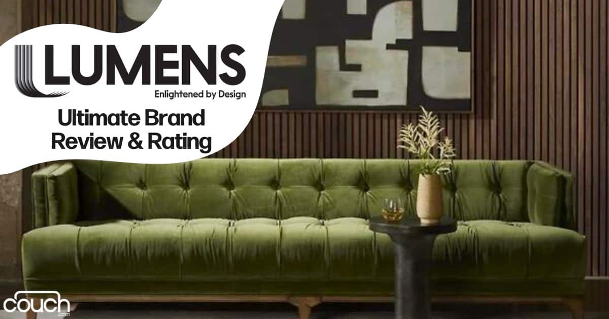 A cozy living room with an olive-green tufted sofa in front of a wooden slatted wall. Above the sofa hangs a geometric black-and-white abstract painting. There is a small side table with a vase and plant on it. Text reads "LUMENS Ultimate Brand Review & Rating.