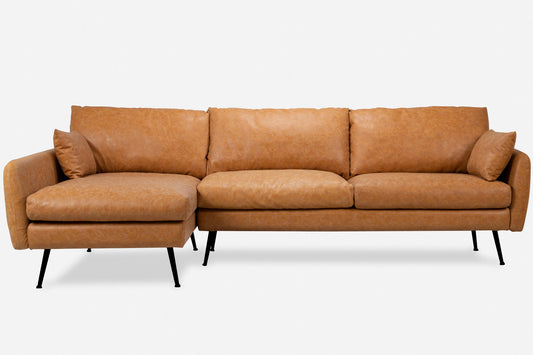 Introducing the Park Sectional Sofa: a modern statement piece featuring rich brown leather upholstery and sleek black metal legs. It includes three backrest cushions, two armrest pillows, and a chaise lounge on the left side. Set against a white backdrop, this sofa's elegant design truly stands out.