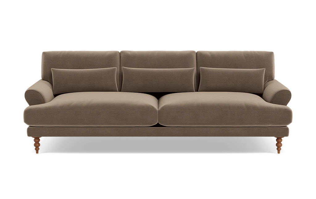 Maxwell Custom Sofa in brown velvet, featuring three seat cushions and three matching throw pillows. It boasts rounded armrests and wooden legs for a classic and cozy design.