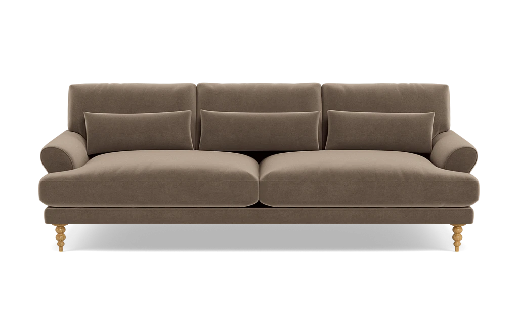 The Maxwell Custom Sofa is a brown, three-seater featuring tufted back cushions and two seat cushions. It is designed with rolled arms and wooden legs that sport a decorative turned design. The sofa is displayed against a plain, white background.