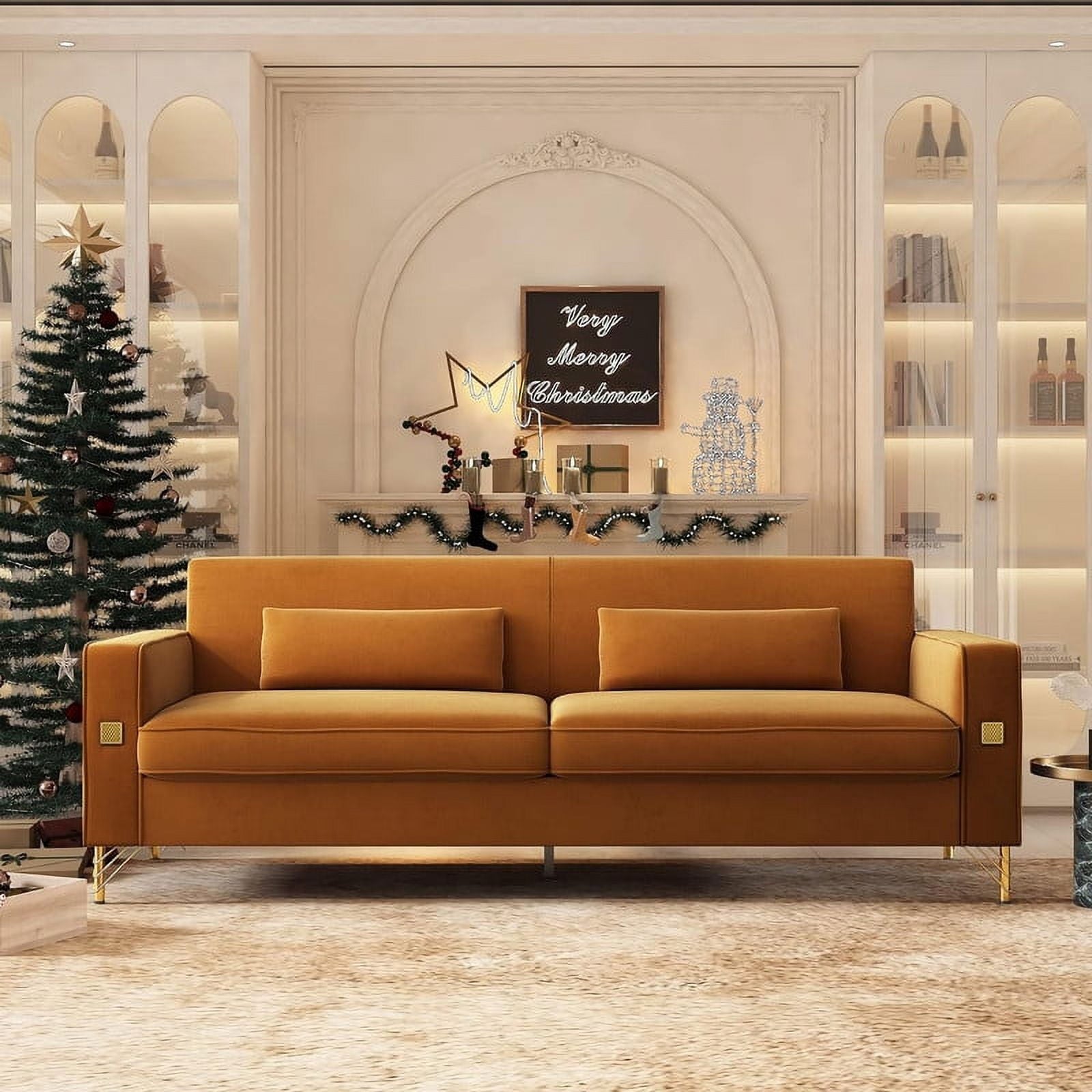 A cozy, festive living room featuring a Mid Century Modern Sofa Couch, a decorated Christmas tree, and shelves filled with books and decor. A lit-up "Very Merry Christmas" sign and holiday decorations adorn the mantel above the couch.