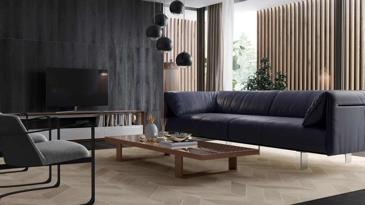 A modern living room with a dark blue leather sofa, a large black TV on a low wooden stand, and a wooden coffee table with a decorative tray. Black pendant lights hang from the ceiling, and the room features large windows with beige vertical blinds and a potted plant.