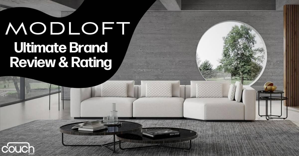 A modern living room with a sleek, minimalist white couch, two round black coffee tables, and large circular window showing greenery outside. The text "MODLOFT Ultimate Brand Review & Rating" is prominently displayed on a black banner. "couch.com" is at the bottom.