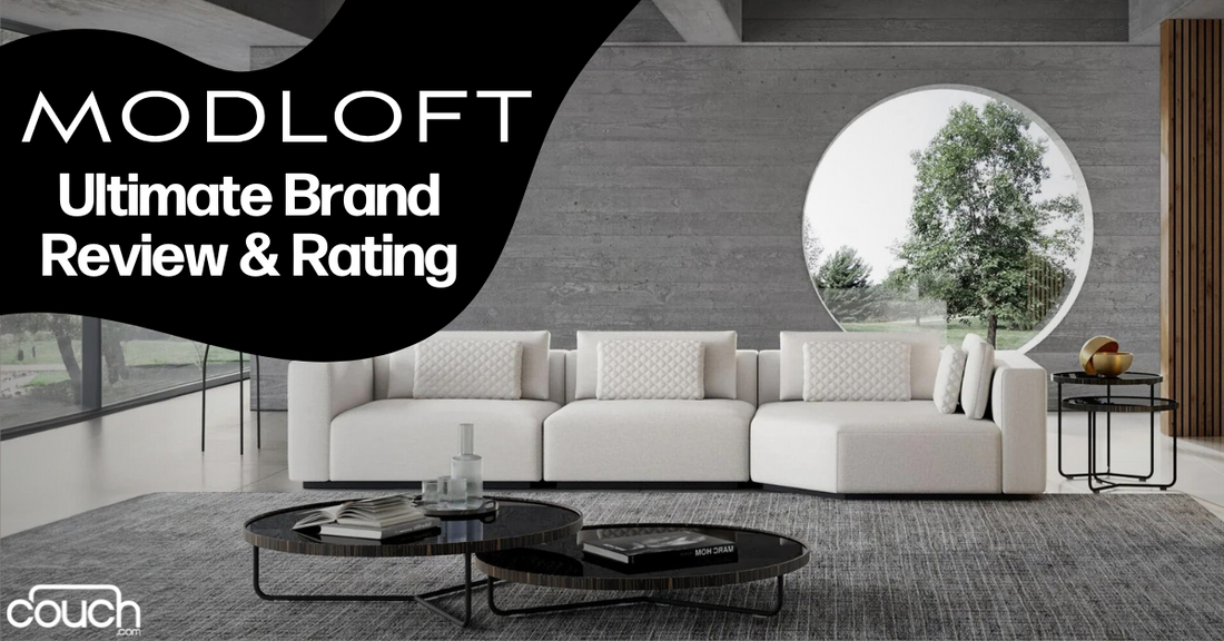 A modern living room with a sleek white sectional sofa placed against a concrete wall. A circular window offers a view of trees outside. A round coffee table with books and decorative items sits on a gray rug. The text reads "MODLOFT Ultimate Brand Review & Rating.