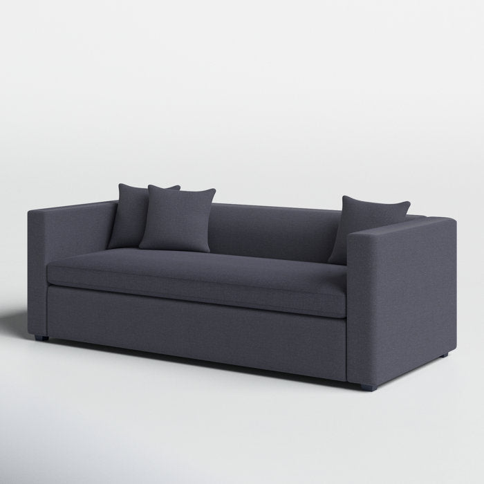 The Mono 81" Sleeper Sofa is a modern, minimalist piece in dark gray with square arms and a clean silhouette. It includes two matching throw pillows and stands against a plain white background.