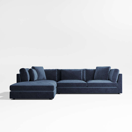 The Monterey Modular 3 Piece L Shaped Sectional Sofa is a sleek and minimalist modern design in dark blue, featuring plush cushions against a plain white background, with clean lines and textured fabric.