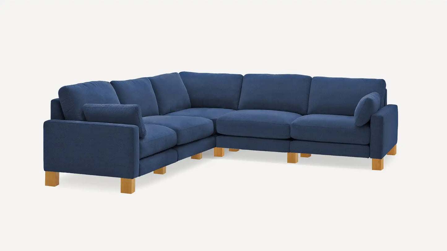 The Union Fabric Modular 5-Seat Sofa Sectional is a spacious and stylish piece with a modern design, featuring an L-shaped configuration, multiple cushioned seats and backrests, and elegant wooden legs in a large blue finish suitable for any expansive living room.