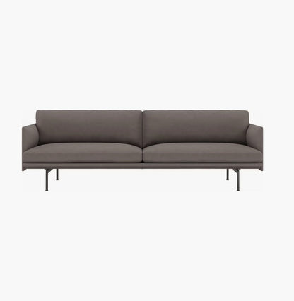 The Outline Sofa 3 Seater is a modern gray sofa boasting a sleek design with two seat cushions and a minimalist metal frame featuring thin legs. It includes a straight backrest and armrests, offering a contemporary appearance against a plain white background.