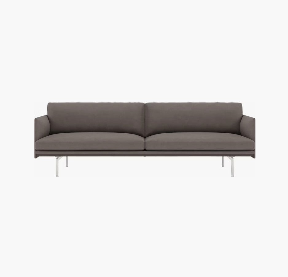 The Outline Sofa 3 Seater is a modern piece with a sleek design, featuring a low back and cushioned seat, supported by thin metal legs. Its minimalist aesthetic makes it perfect for contemporary interiors.