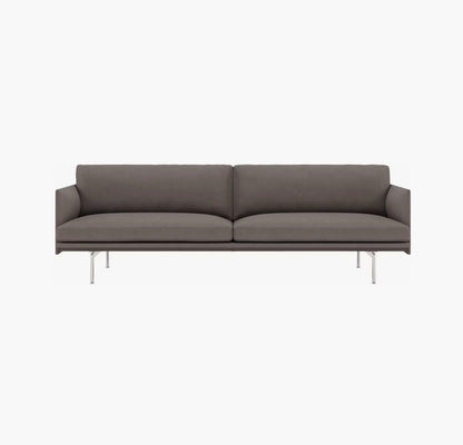 The Outline Sofa 3 Seater is a modern piece with a sleek design, featuring a low back and cushioned seat, supported by thin metal legs. Its minimalist aesthetic makes it perfect for contemporary interiors.