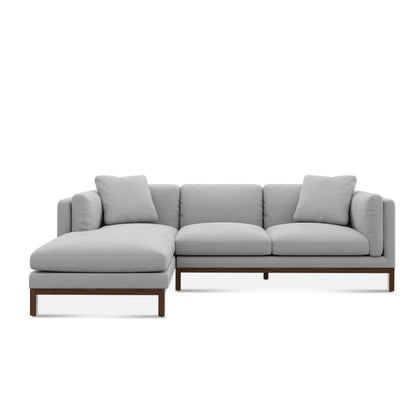 Introducing the Owen Chaise Sectional Sofa—a contemporary sectional with an L-shape design in light gray. It features a left-side chaise lounge, three seat cushions, wooden legs, and comes with plush back pillows for added comfort.