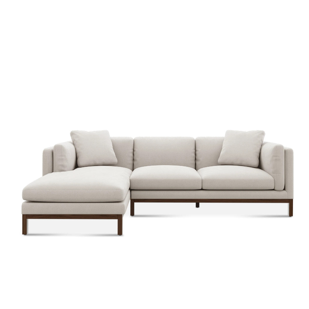 The Owen Chaise Sectional Sofa is a contemporary beige piece featuring a wooden base and clean lines, complete with a chaise on the left and minimalist cushions for enhanced comfort and modern style.