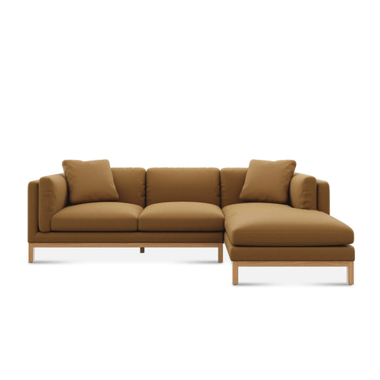 The Owen Chaise Sectional Sofa, featuring plush cushions and a modern design, is displayed on a plain white background with its right-side chaise in brown.