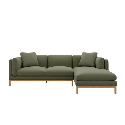 The Owen Chaise Sectional Sofa is a modern and minimalist piece, available in green, featuring a right-side chaise and wooden legs. It comes with matching green cushions, making it ideal for a stylish living room setup.