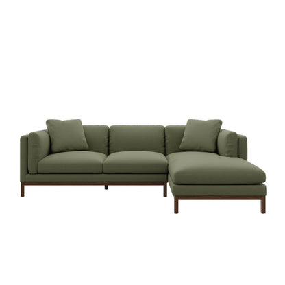 Introducing the Owen Chaise Sectional Sofa, a green L-shaped sectional with plush cushions and a sturdy wooden frame. Its design boasts clean lines and a modern aesthetic, making it the ideal addition to any contemporary living space.