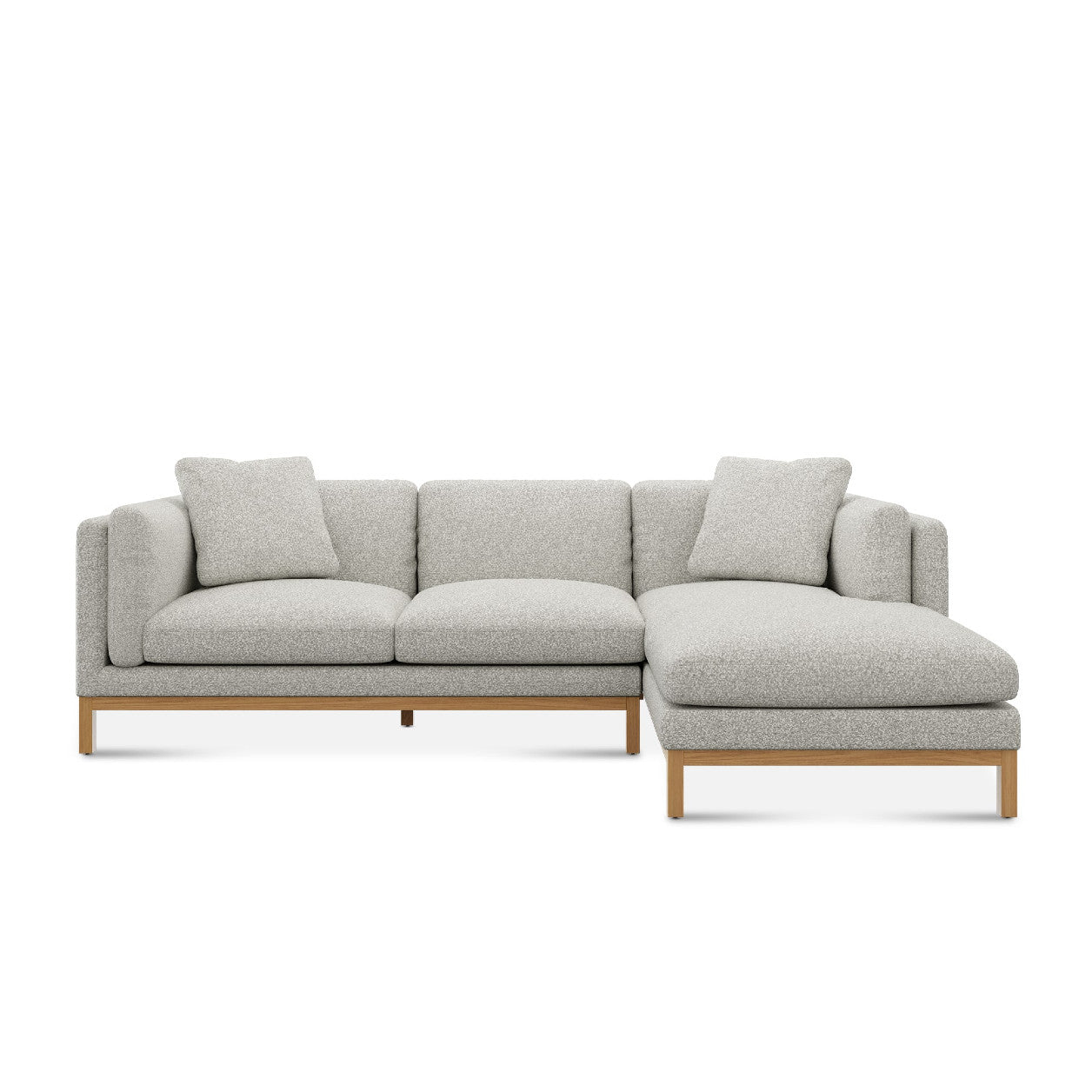 The Owen Chaise Sectional Sofa features a contemporary L-shape with light gray fabric upholstery and wooden legs. It is designed with a right-side chaise and comes with matching cushions.