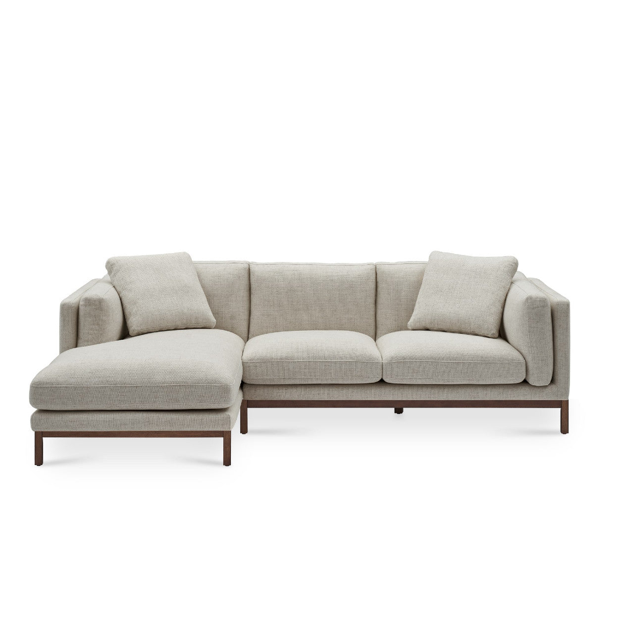 The Owen Chaise Sectional Sofa is a light gray, L-shaped design featuring wooden legs and three seat cushions. It includes two back cushions and two larger arm cushions, offering a modern and comfortable look.