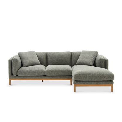 Introducing the Owen Chaise Sectional Sofa, featuring green upholstery and wooden legs. This modern piece includes a right-hand chaise and comes with two matching cushions, offering a sleek and contemporary design.