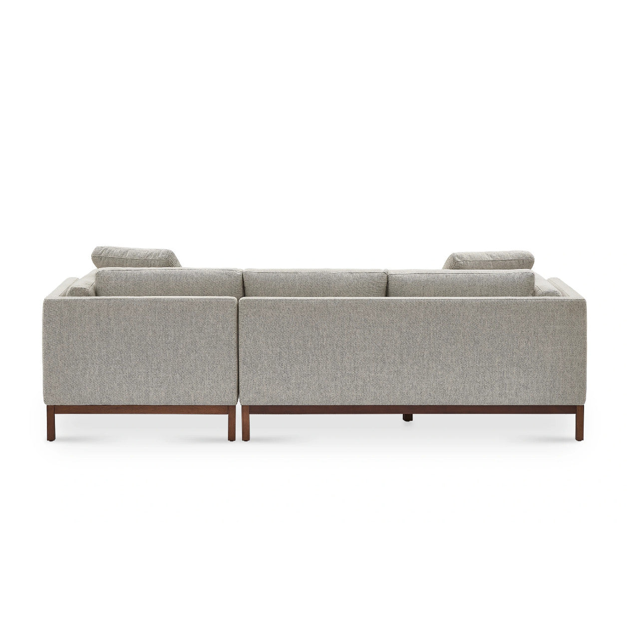 The image depicts the back view of the Owen Chaise Sectional Sofa, showcasing its modern light gray upholstery complemented by wooden legs. The design is characterized by clean lines and a minimalist aesthetic that contribute to its sleek, contemporary look.