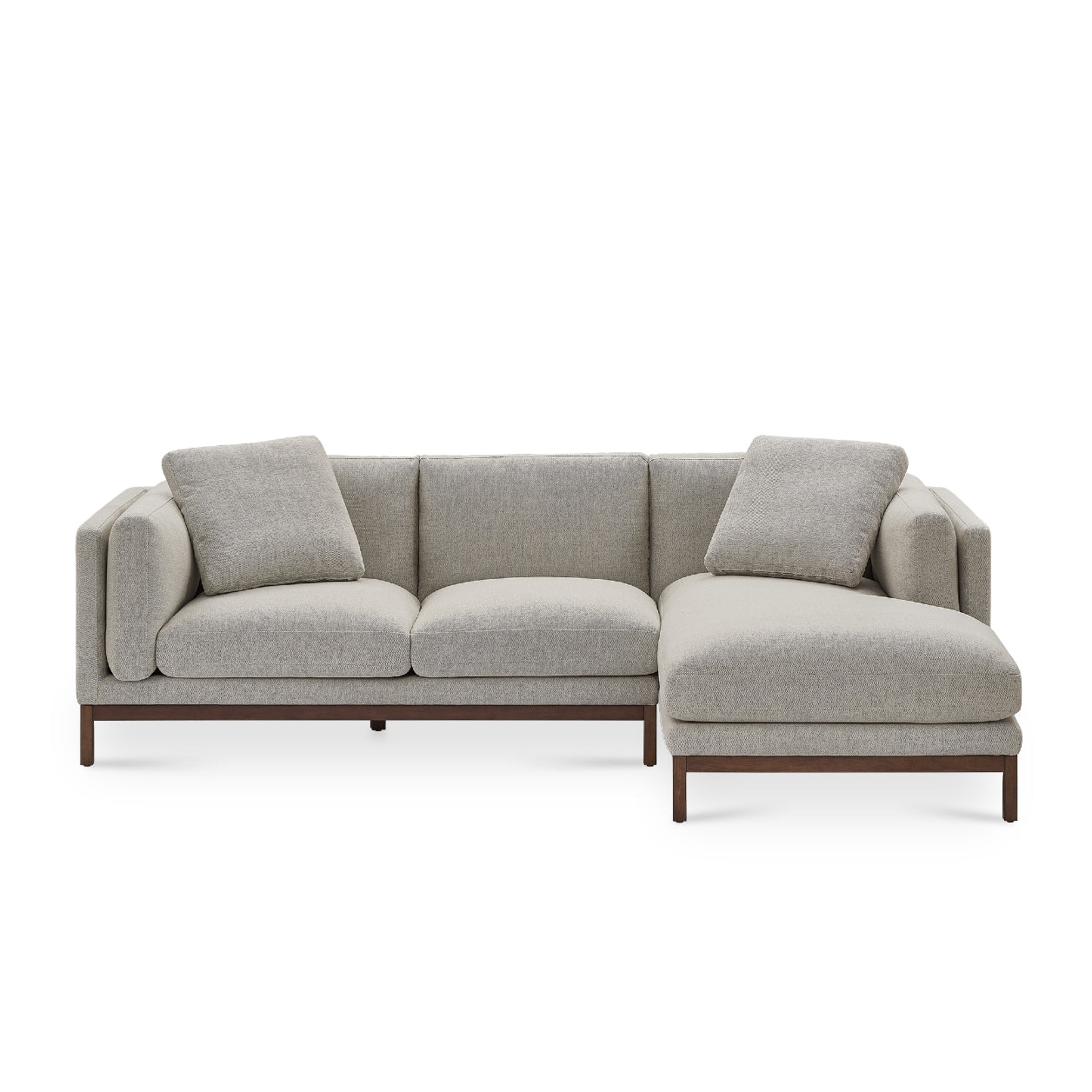 The Owen Chaise Sectional Sofa is a modern L-shaped sectional in gray, featuring plush cushions and low-profile wooden legs, set against a white background.