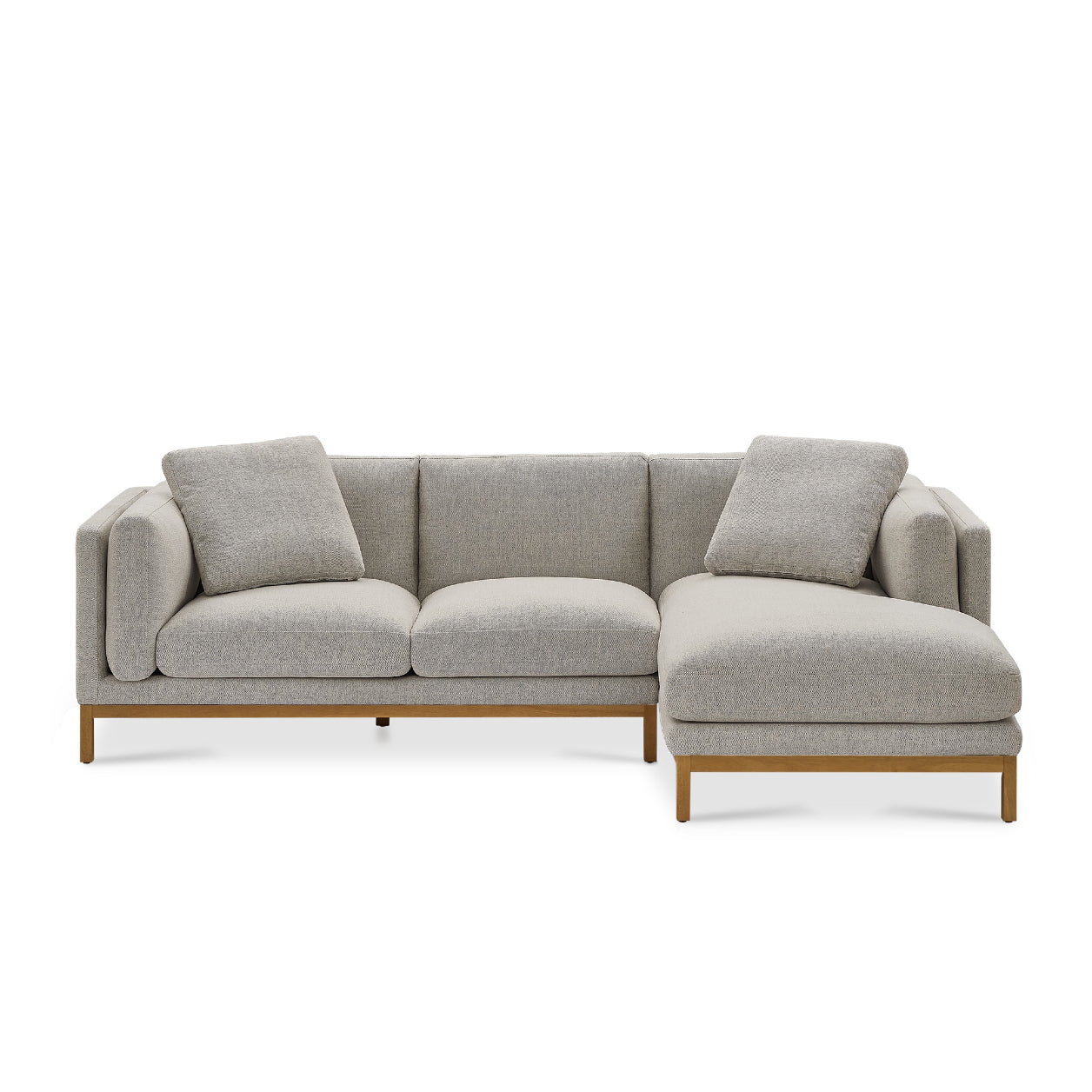 The Owen Chaise Sectional Sofa is a contemporary L-shaped couch with light gray cushions and wooden legs. It comes with two matching pillows and showcases clean lines and a minimalist design.